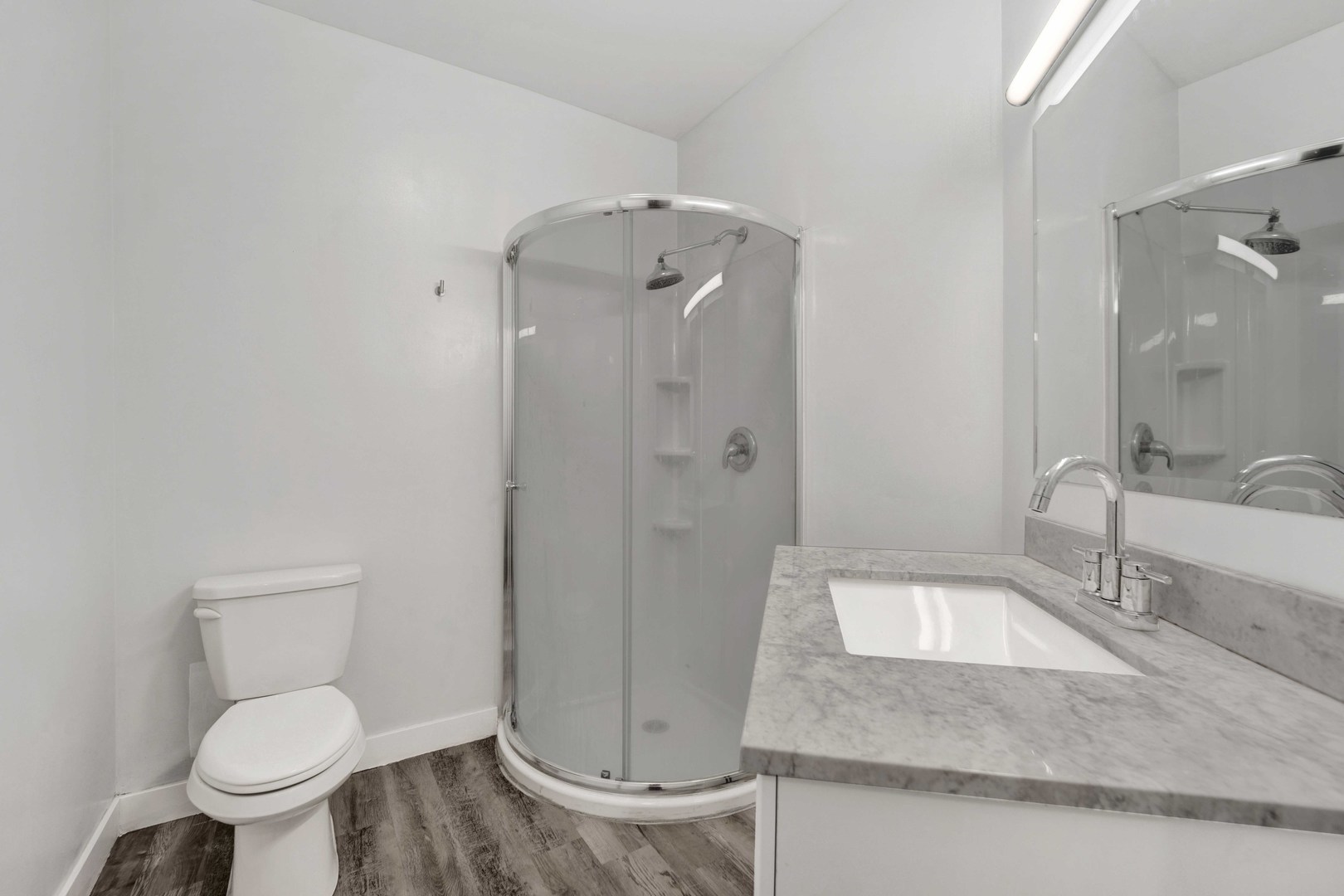 2413 West Polk Street, Unit 2 Chicago, IL 60612 - Photo 10 of 16 a bathroom with a granite countertop sink toilet and shower