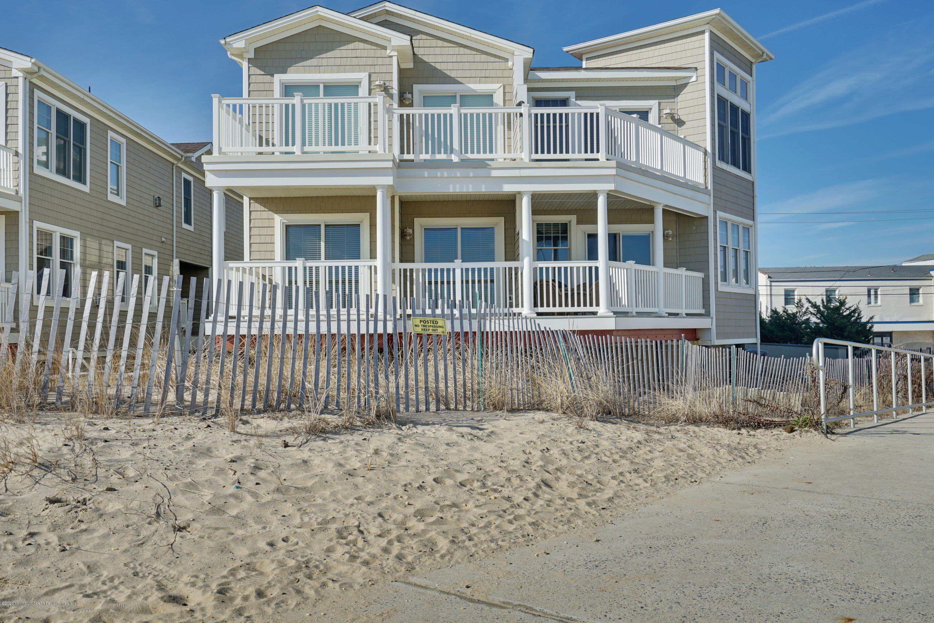 209 Beach Front, Unit 1 Manasquan, NJ 08736 - Photo 1 of 40 a front view of a house with a fence