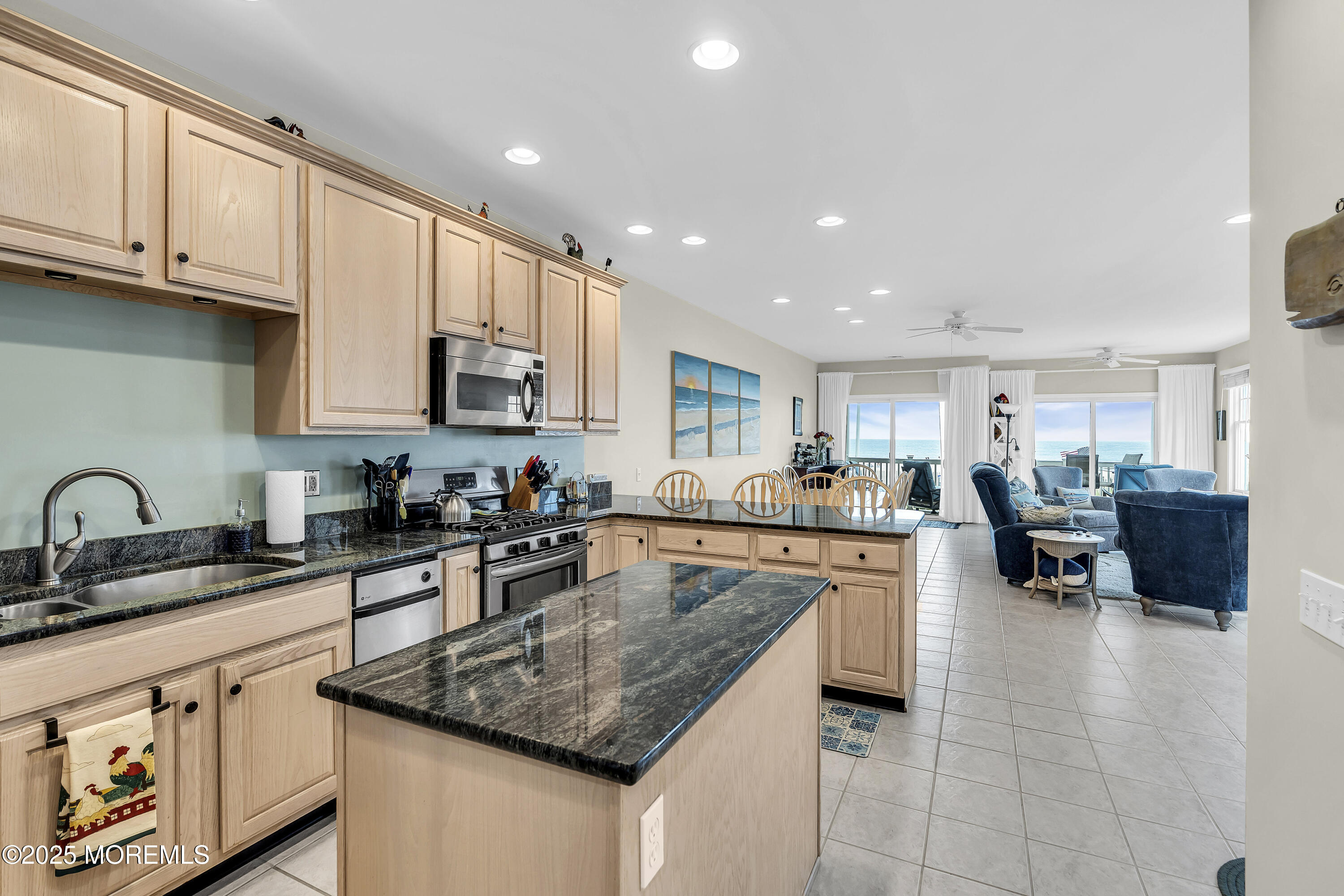 209 Beach Front, Unit 1 Manasquan, NJ 08736 - Photo 13 of 40 a kitchen with stainless steel appliances granite countertop a sink a stove top oven a counter space and cabinets