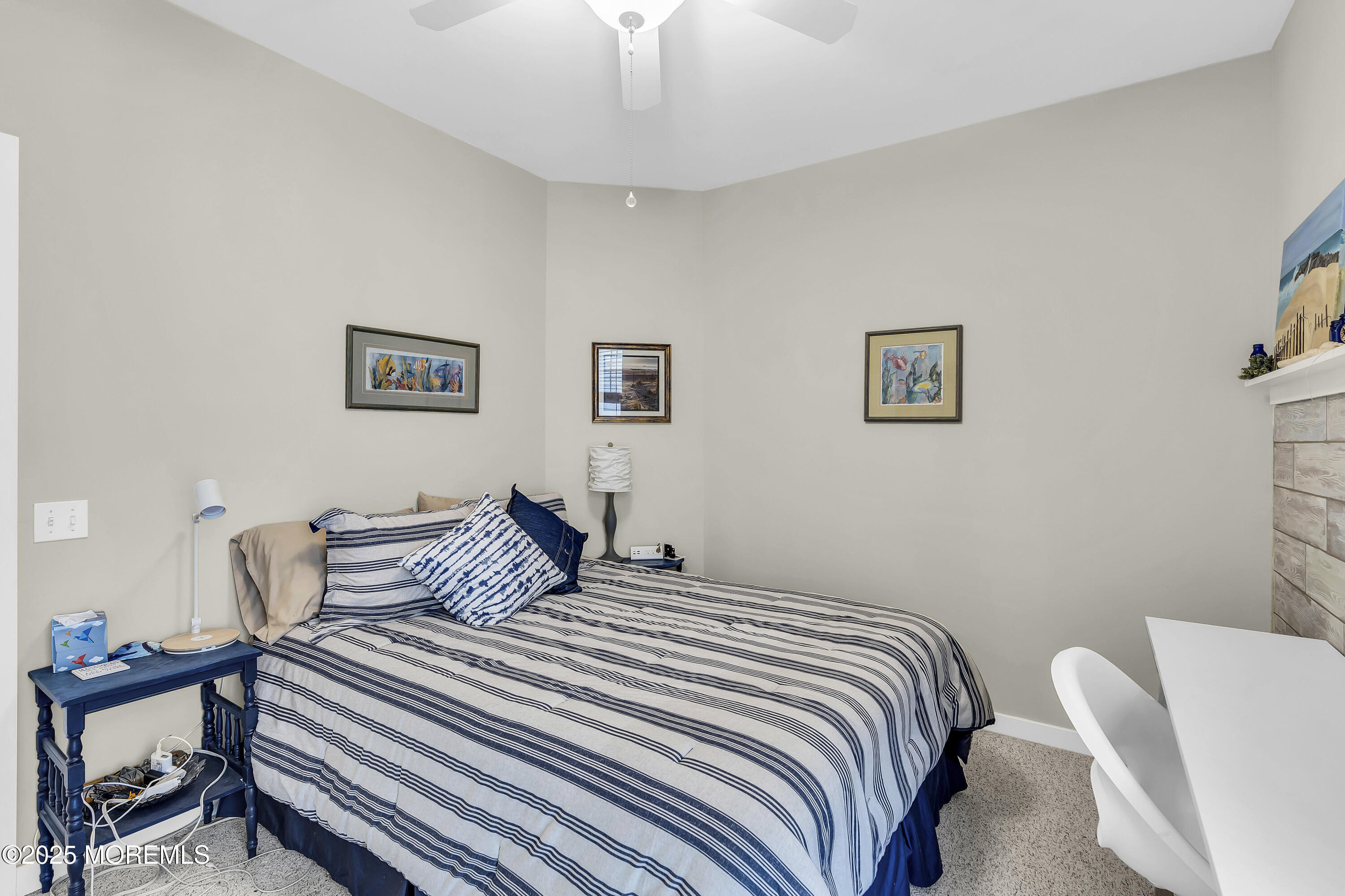 209 Beach Front, Unit 1 Manasquan, NJ 08736 - Photo 17 of 40 a bedroom with a bed and a painting on the wall