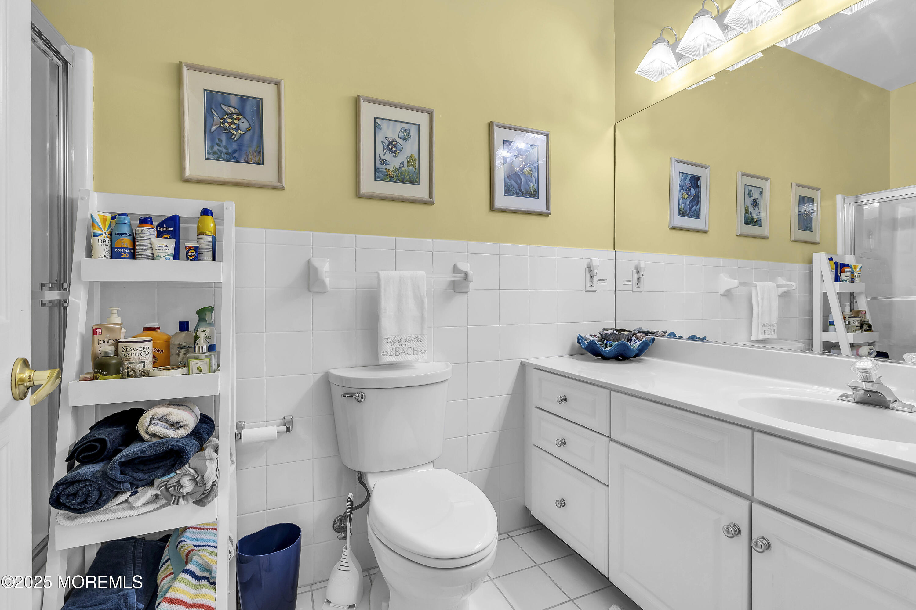 209 Beach Front, Unit 1 Manasquan, NJ 08736 - Photo 18 of 40 a bathroom with a toilet sink and mirror