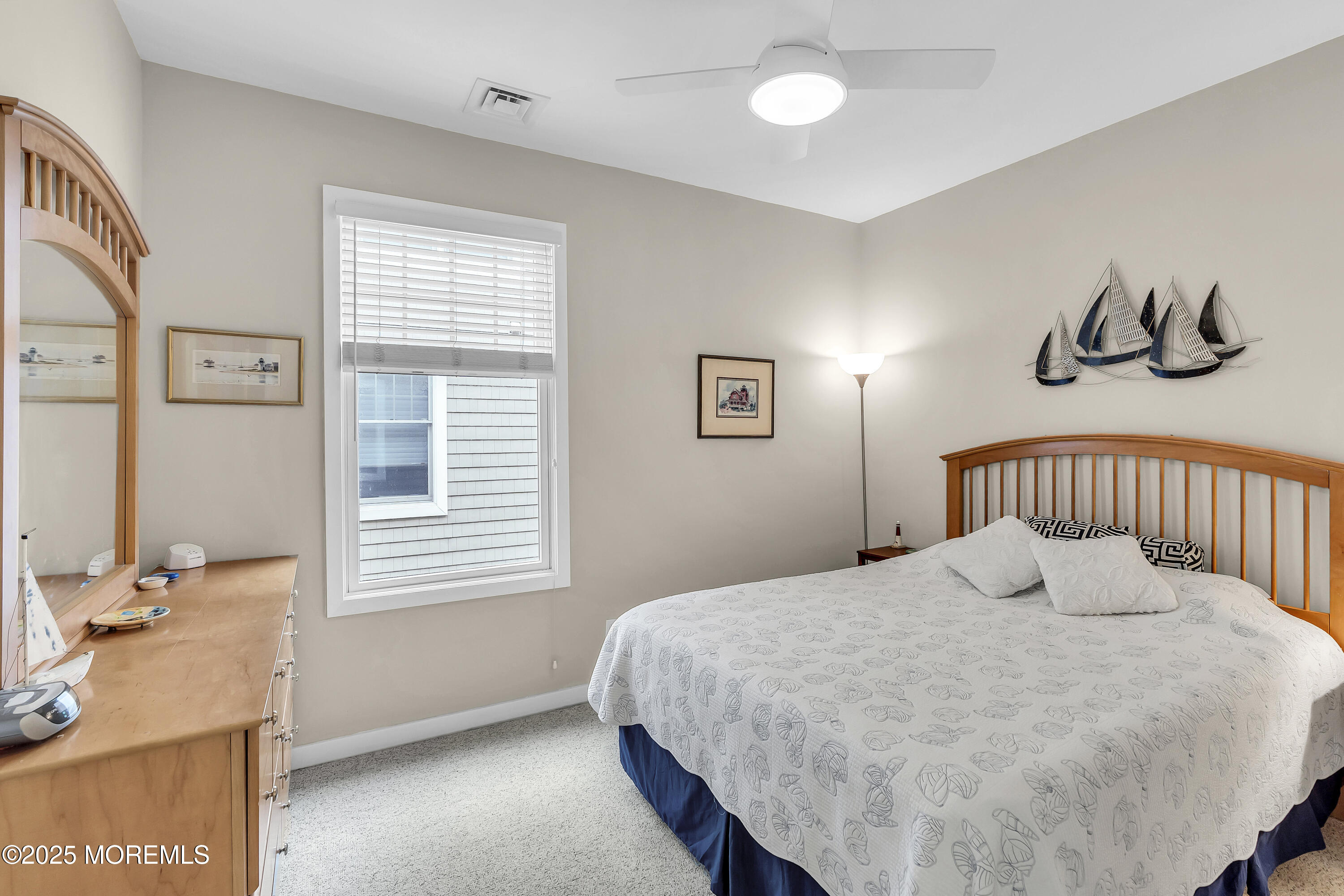 209 Beach Front, Unit 1 Manasquan, NJ 08736 - Photo 19 of 40 a bedroom with a bed and window