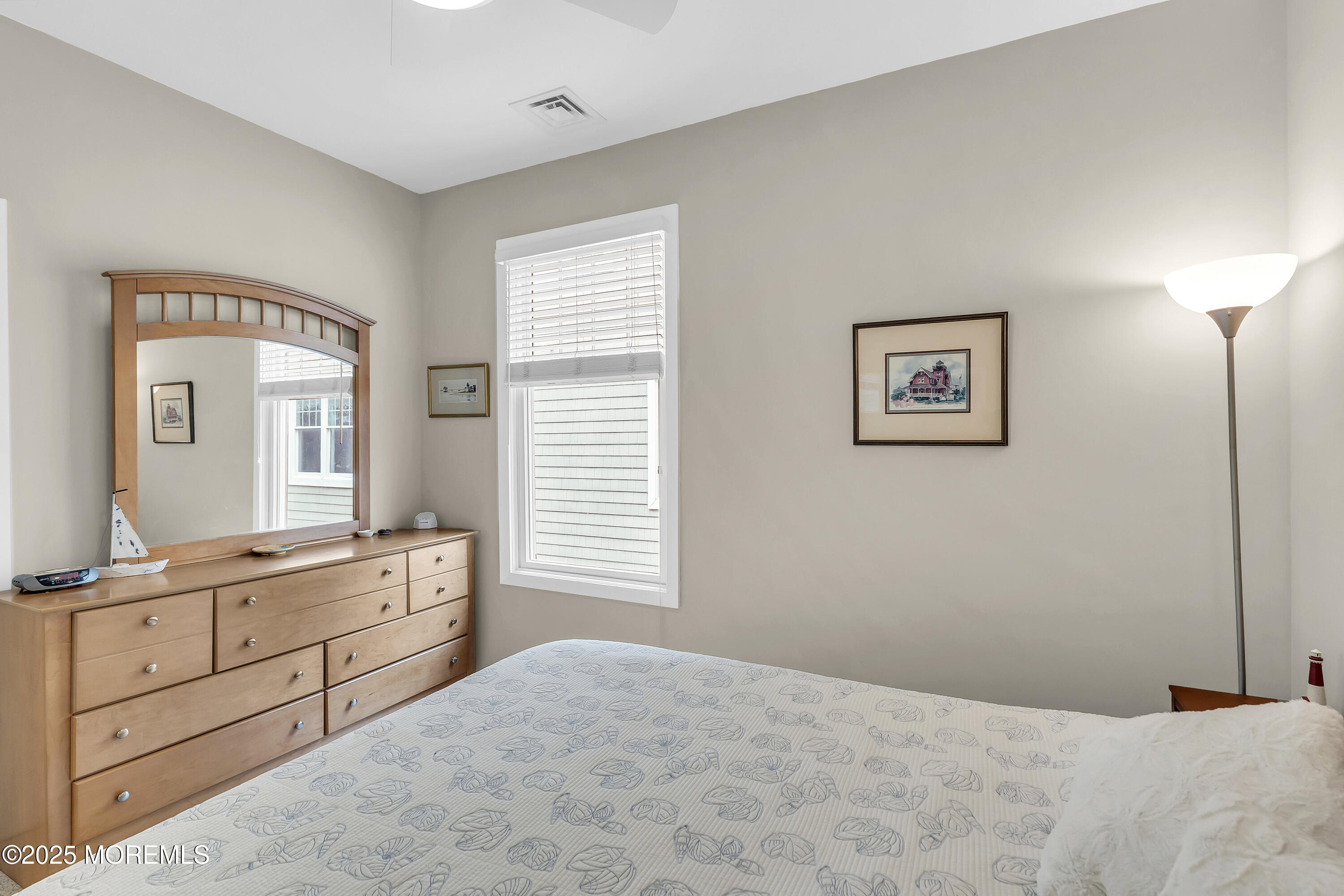 209 Beach Front, Unit 1 Manasquan, NJ 08736 - Photo 20 of 40 a bedroom with a bed and a window