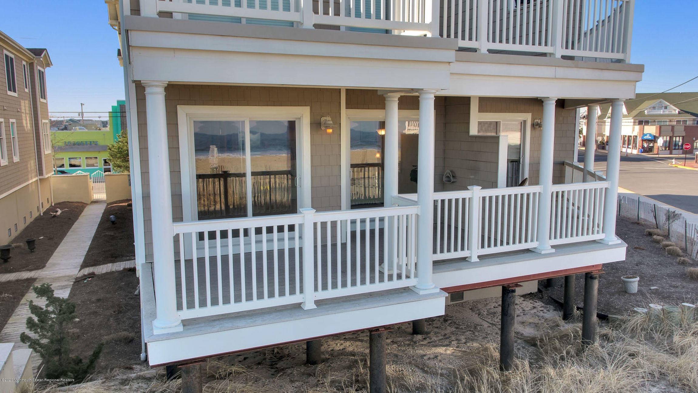 209 Beach Front, Unit 1 Manasquan, NJ 08736 - Photo 2 of 40 a view of a deck with a chair and floor to ceiling window