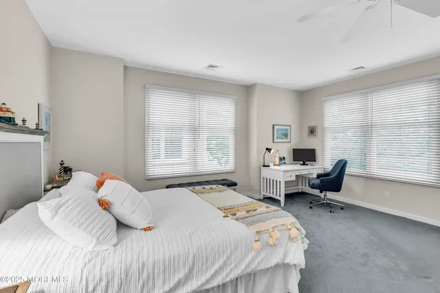 a bedroom with two beds and a chair