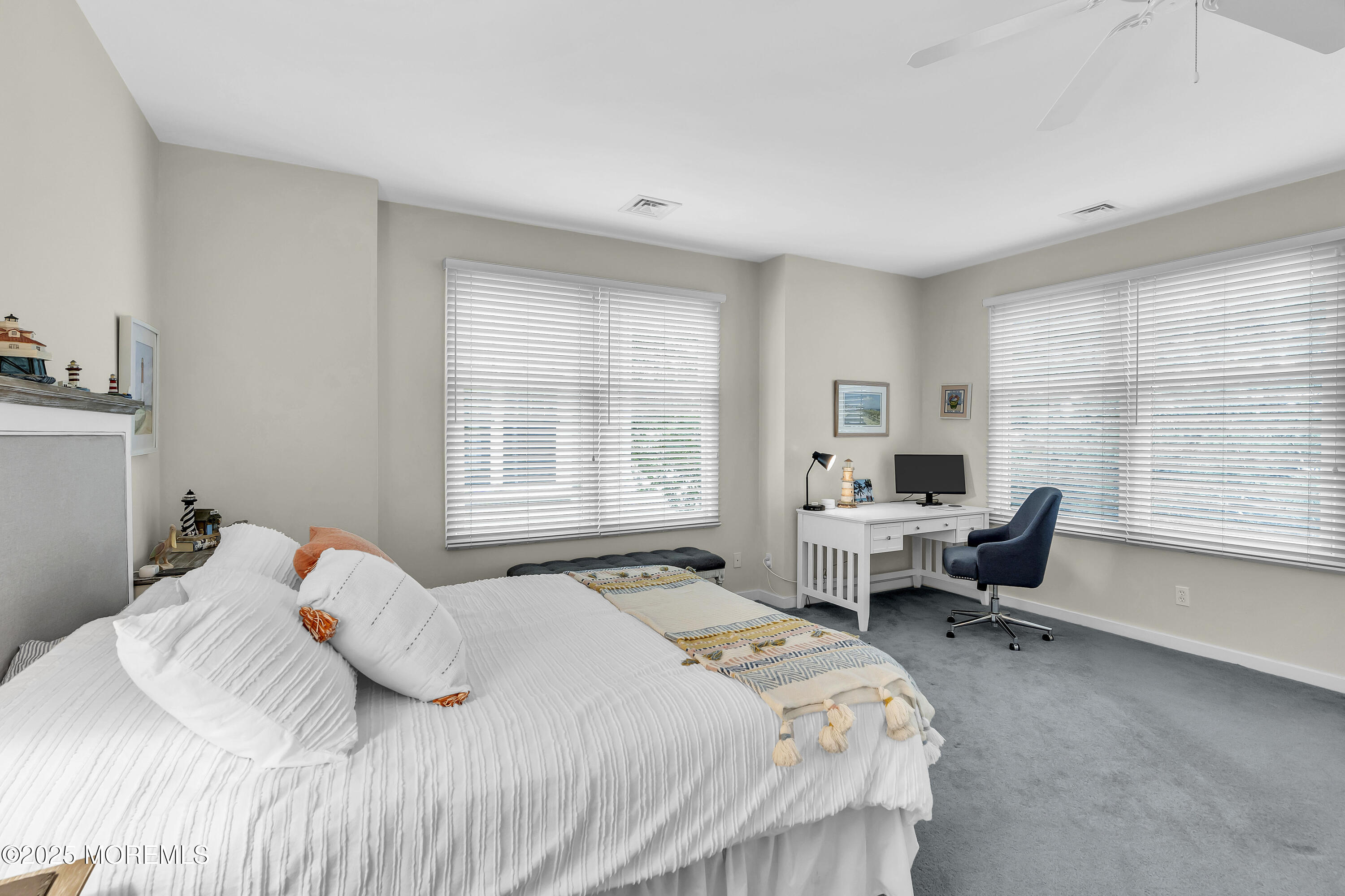 209 Beach Front, Unit 1 Manasquan, NJ 08736 - Photo 21 of 40 a bedroom with a bed and a large window
