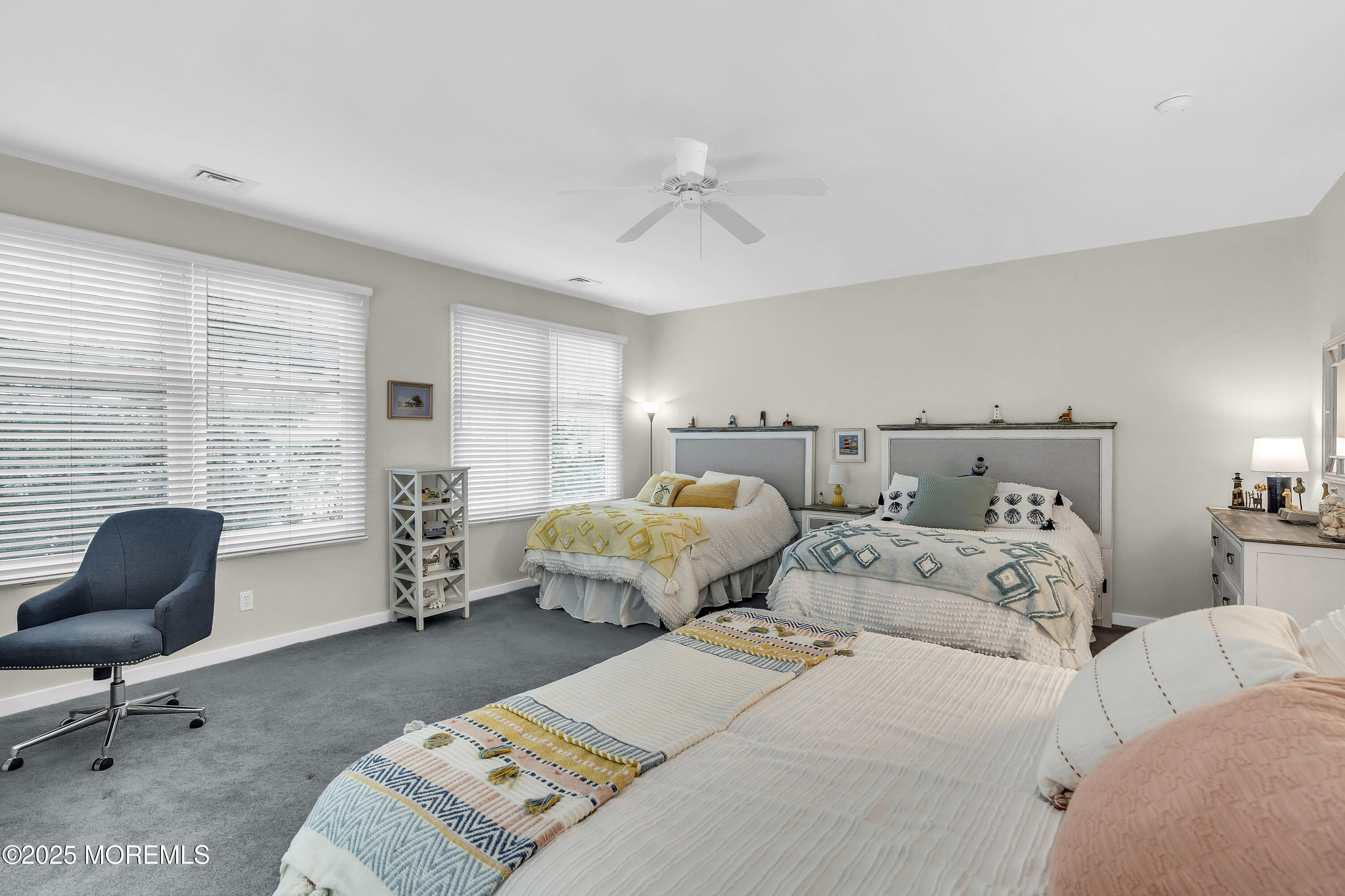 209 Beach Front, Unit 1 Manasquan, NJ 08736 - Photo 22 of 40 a bedroom with two beds and a chair