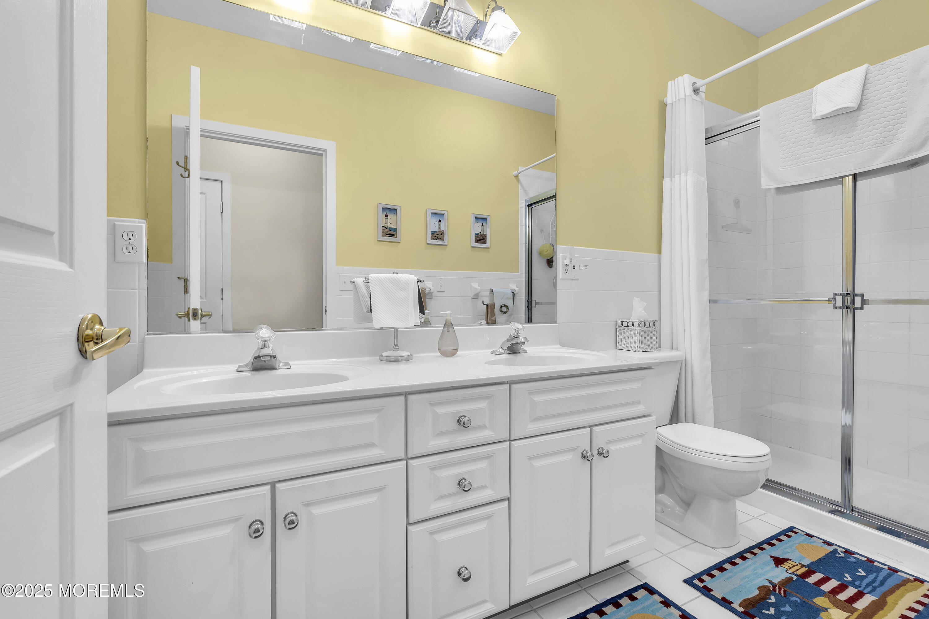 209 Beach Front, Unit 1 Manasquan, NJ 08736 - Photo 25 of 40 a bathroom with a double vanity sink toilet and a mirror