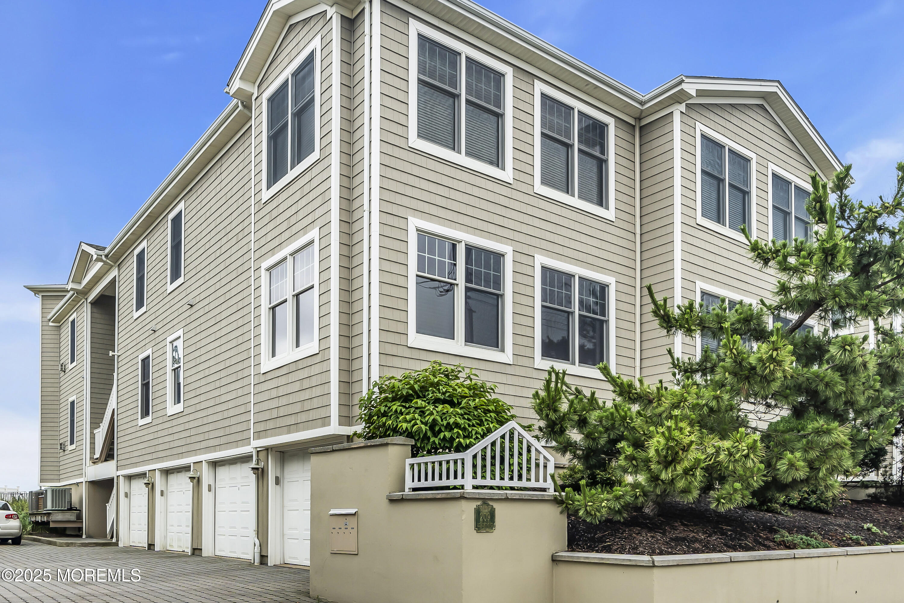 209 Beach Front, Unit 1 Manasquan, NJ 08736 - Photo 28 of 40 a front view of a house with a yard