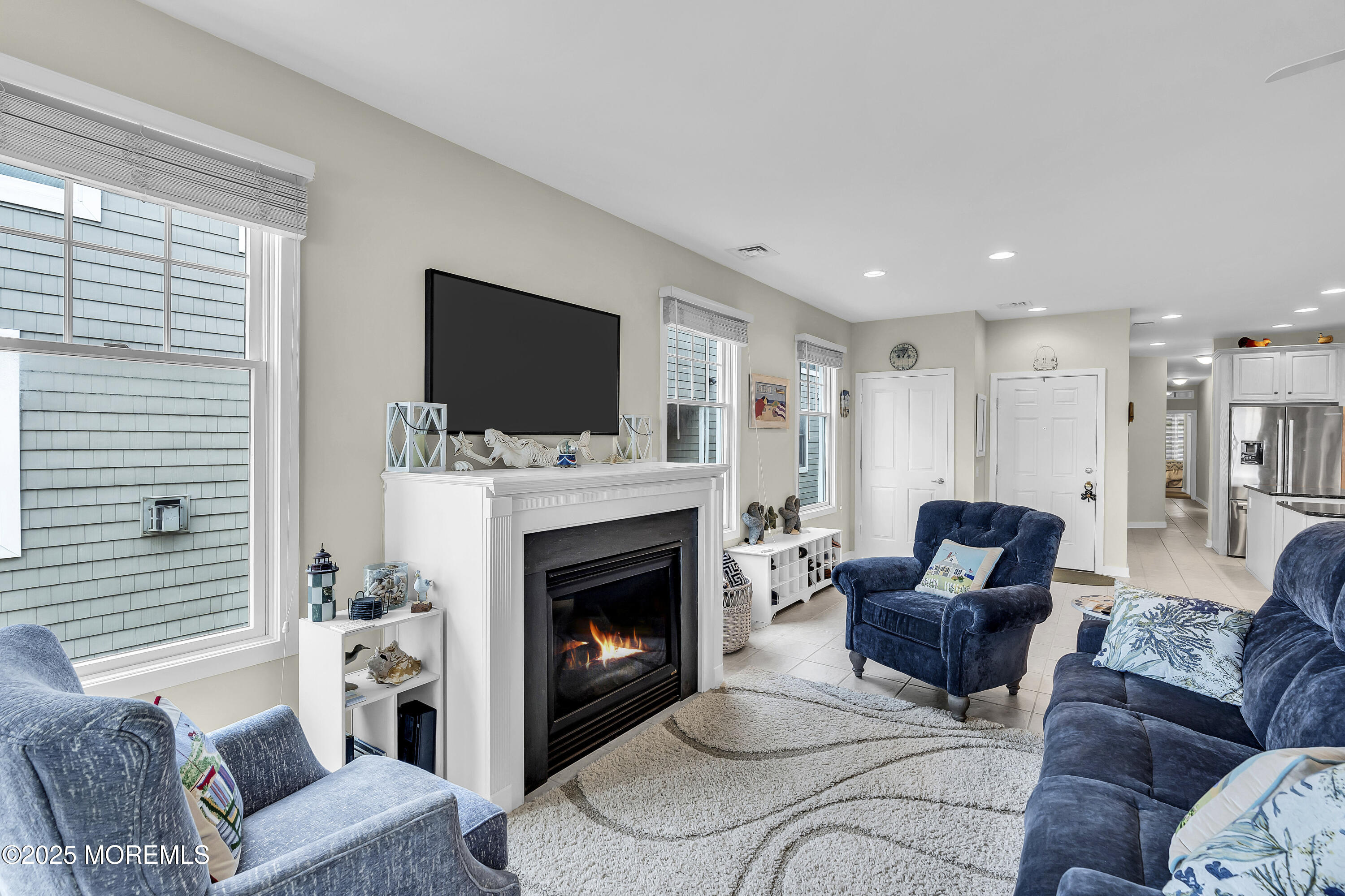 209 Beach Front, Unit 1 Manasquan, NJ 08736 - Photo 5 of 40 a living room with furniture a flat screen tv and a fireplace