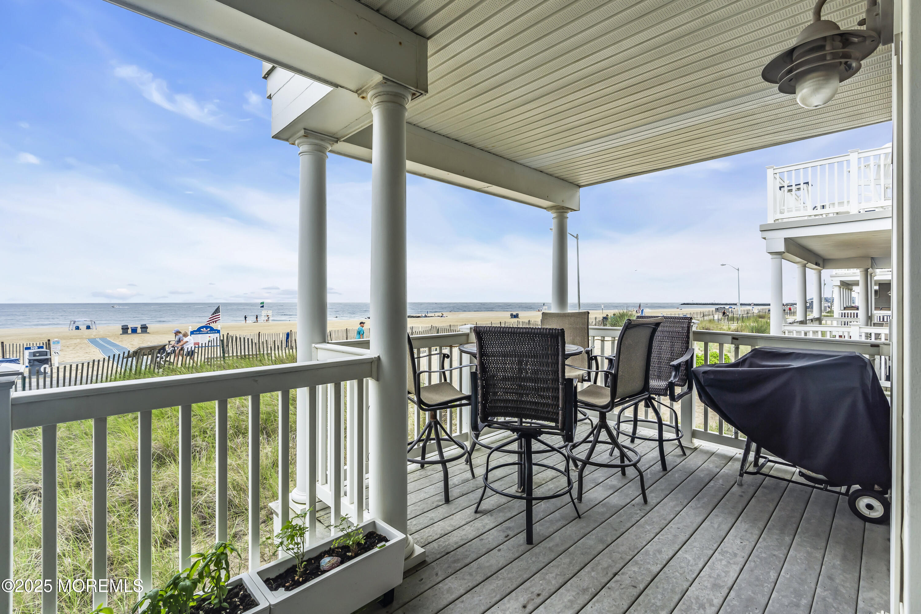 209 Beach Front, Unit 1 Manasquan, NJ 08736 - Photo 7 of 40 a view of a chairs and table on the deck
