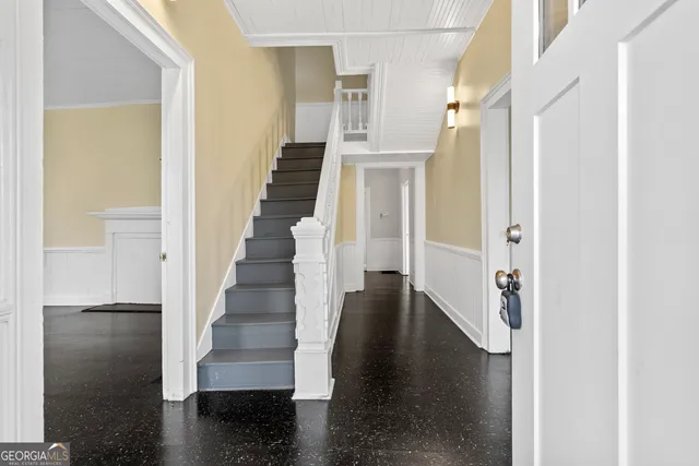 a view of entryway and hall with wooden floor