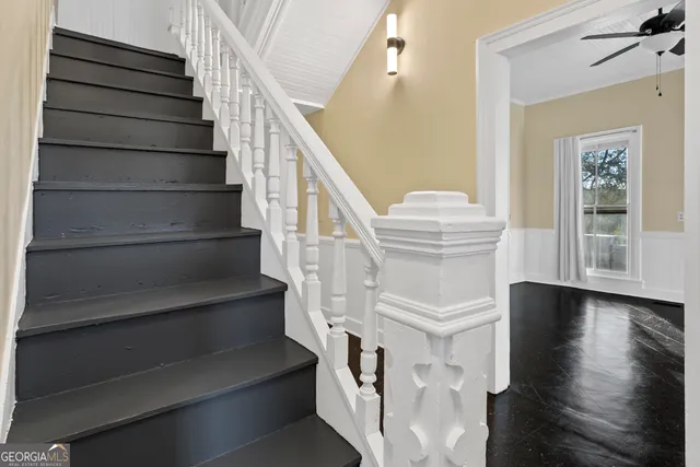 a view of a hallway with wooden floor