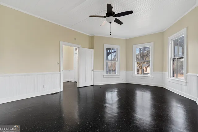 wooden floor in an empty room with a window