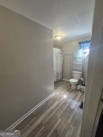 front view of a house with backyard and trees