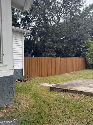 a view of staircase with lots of frames on wall and a window