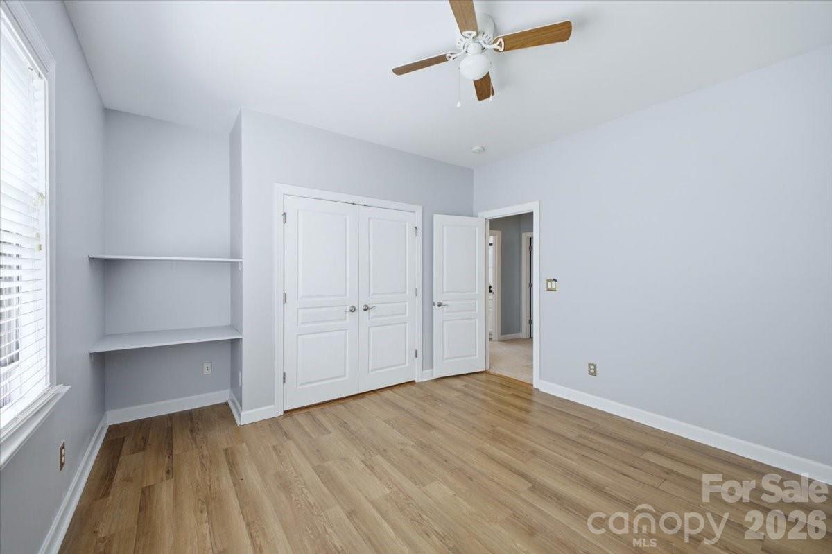 1825 Laveta Road Charlotte, NC 28269 - Photo 28 of 48 a view of empty room with wooden floor and fan