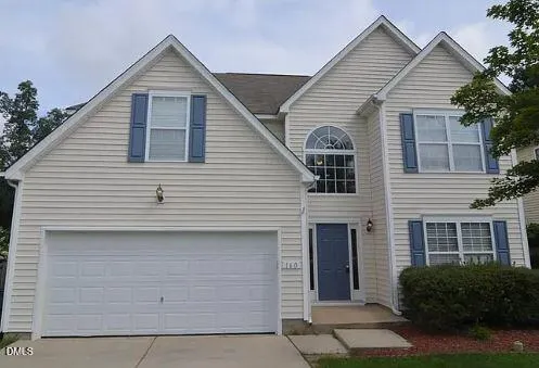 a view of a house with a yard and garage
