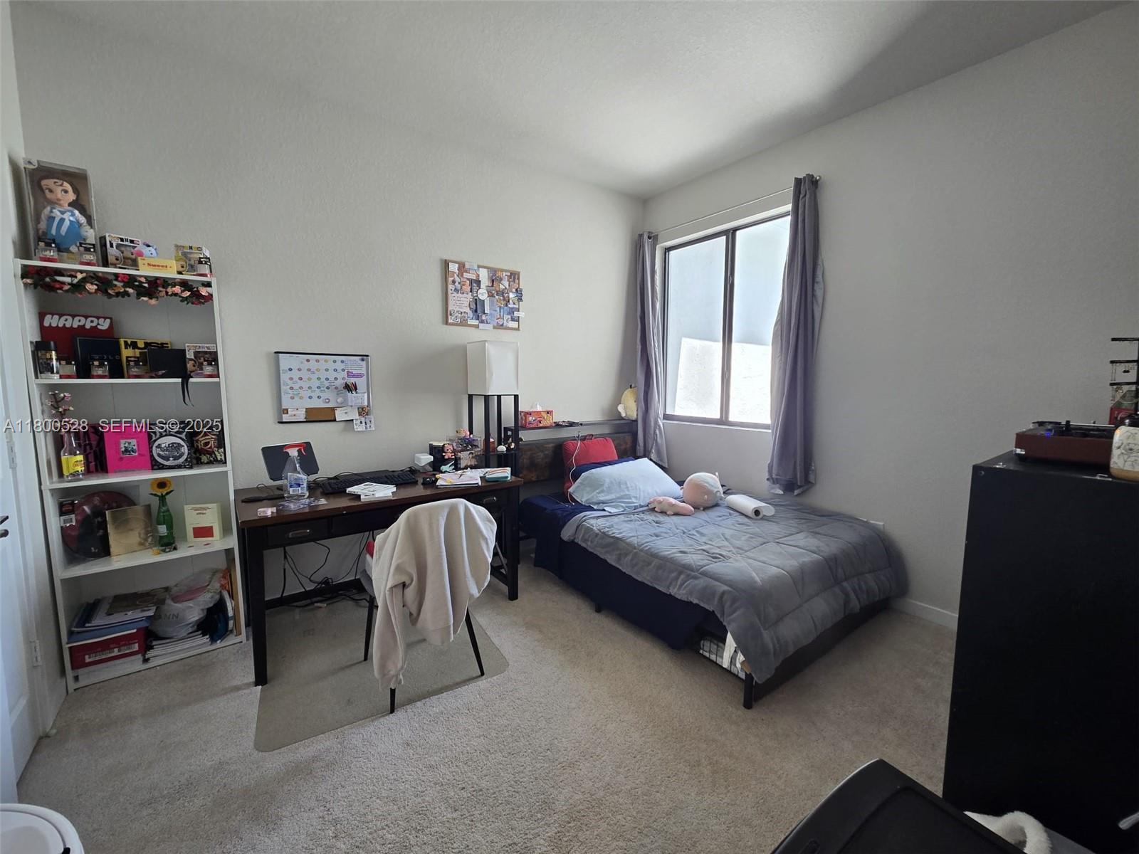 10847 Southwest 232nd Terrace Homestead, FL 33032 - Photo 15 of 29 a bedroom with bed and a large window