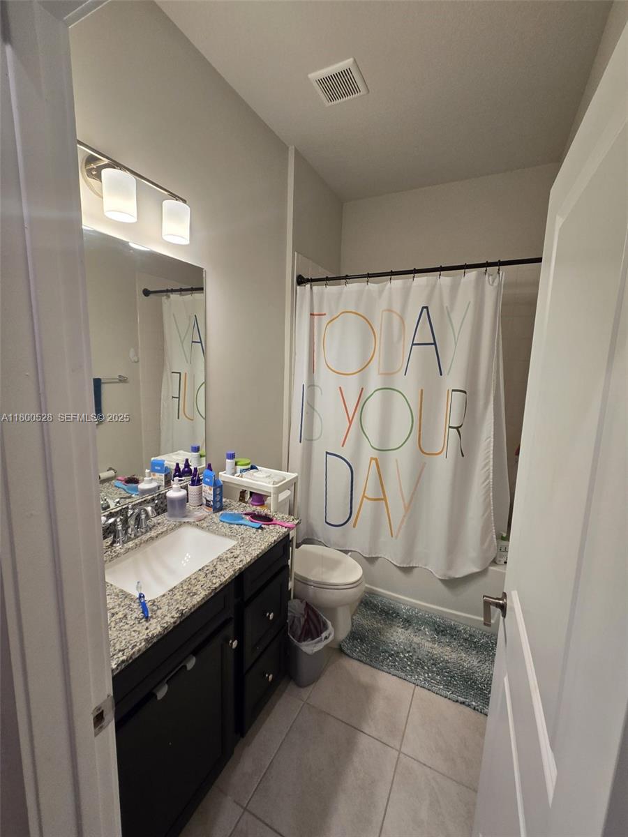 10847 Southwest 232nd Terrace Homestead, FL 33032 - Photo 17 of 29 a bathroom with a sink a toilet and a mirror