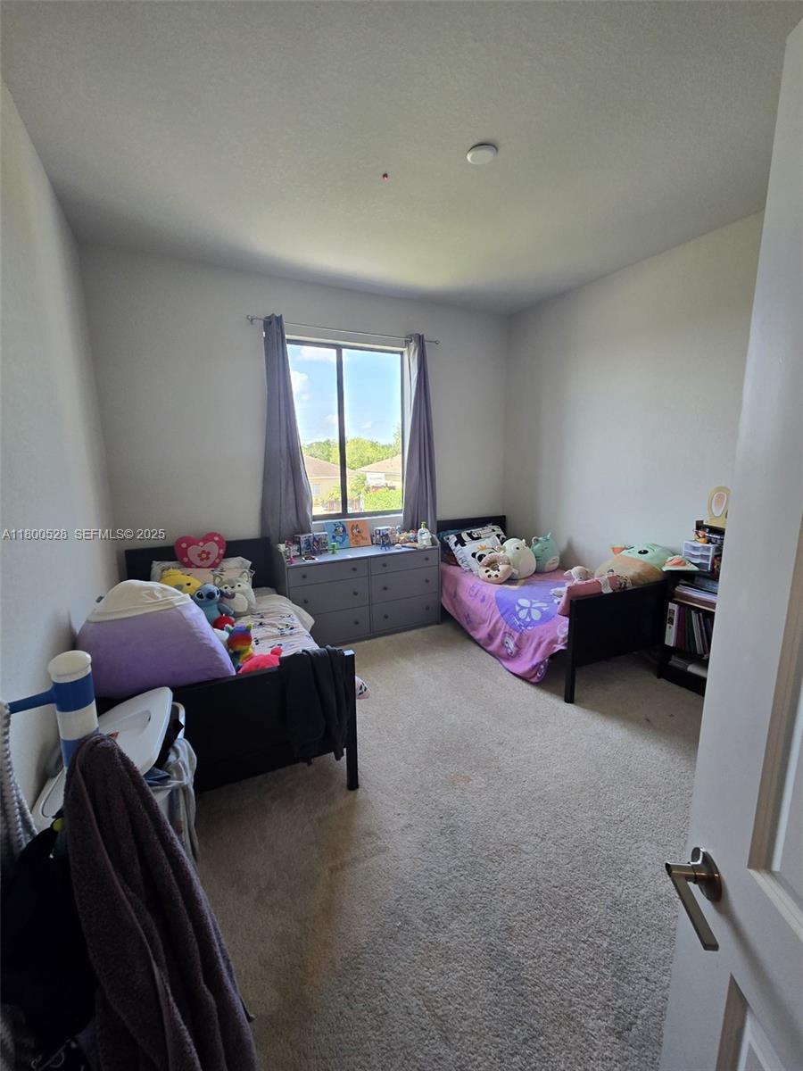 10847 Southwest 232nd Terrace Homestead, FL 33032 - Photo 19 of 29 a bedroom with furniture and a window