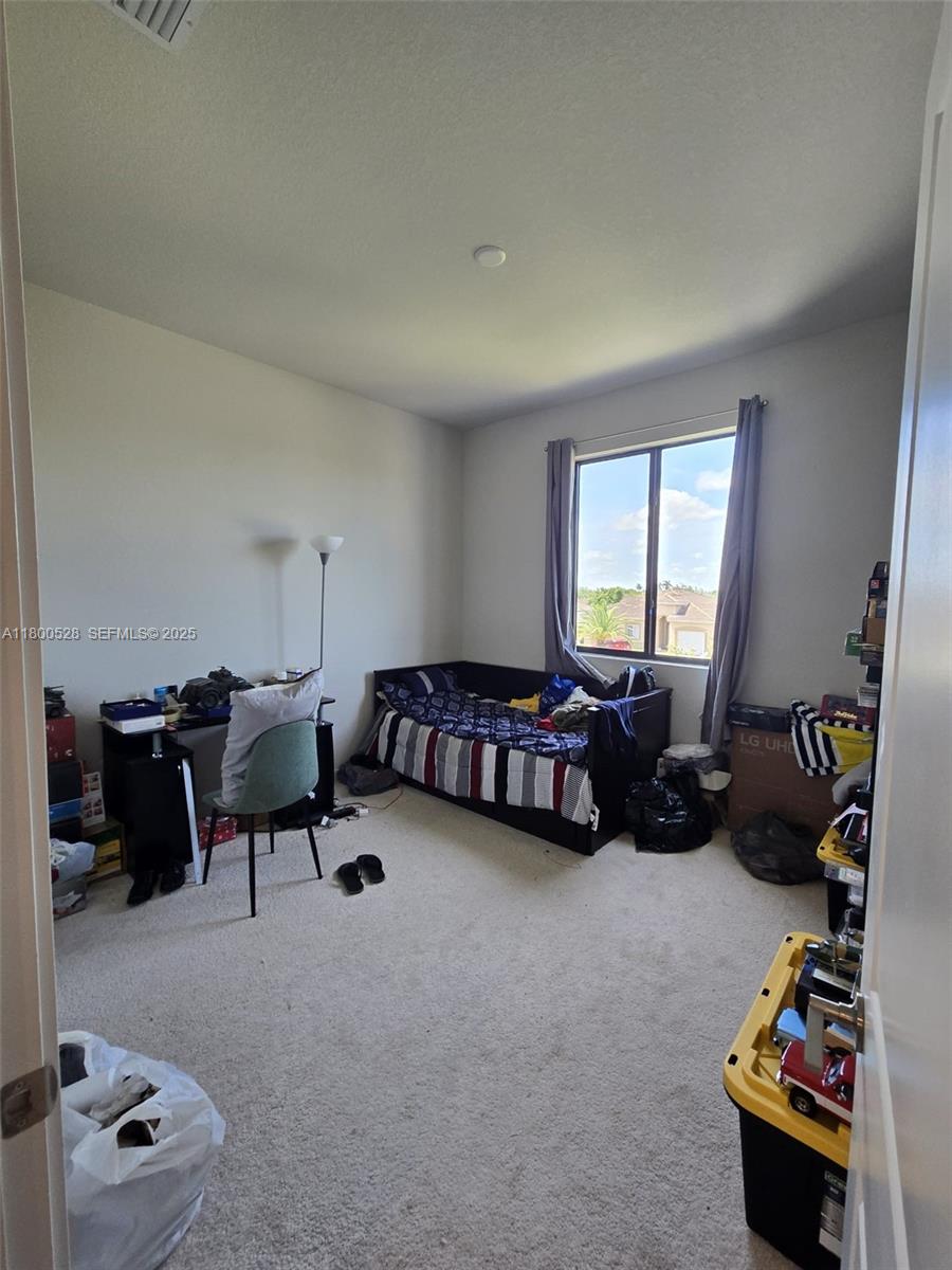 10847 Southwest 232nd Terrace Homestead, FL 33032 - Photo 20 of 29 a living room with furniture and gym equipment