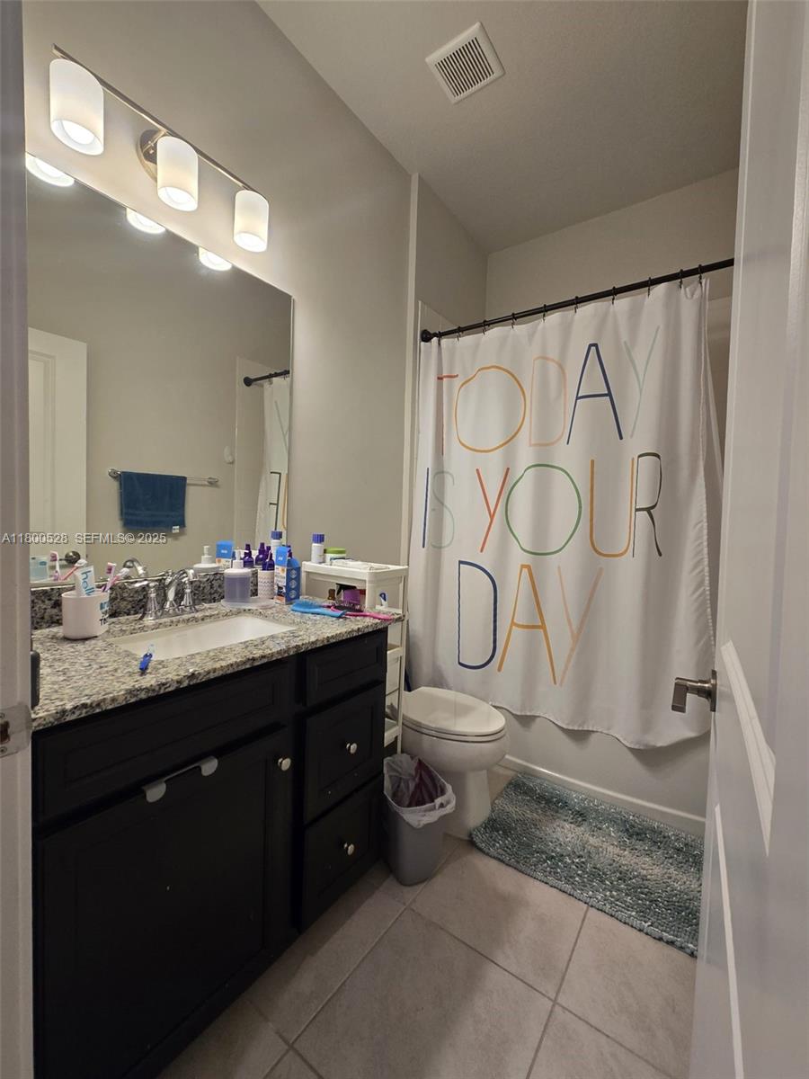 10847 Southwest 232nd Terrace Homestead, FL 33032 - Photo 22 of 29 a bathroom with a granite countertop sink and a mirror