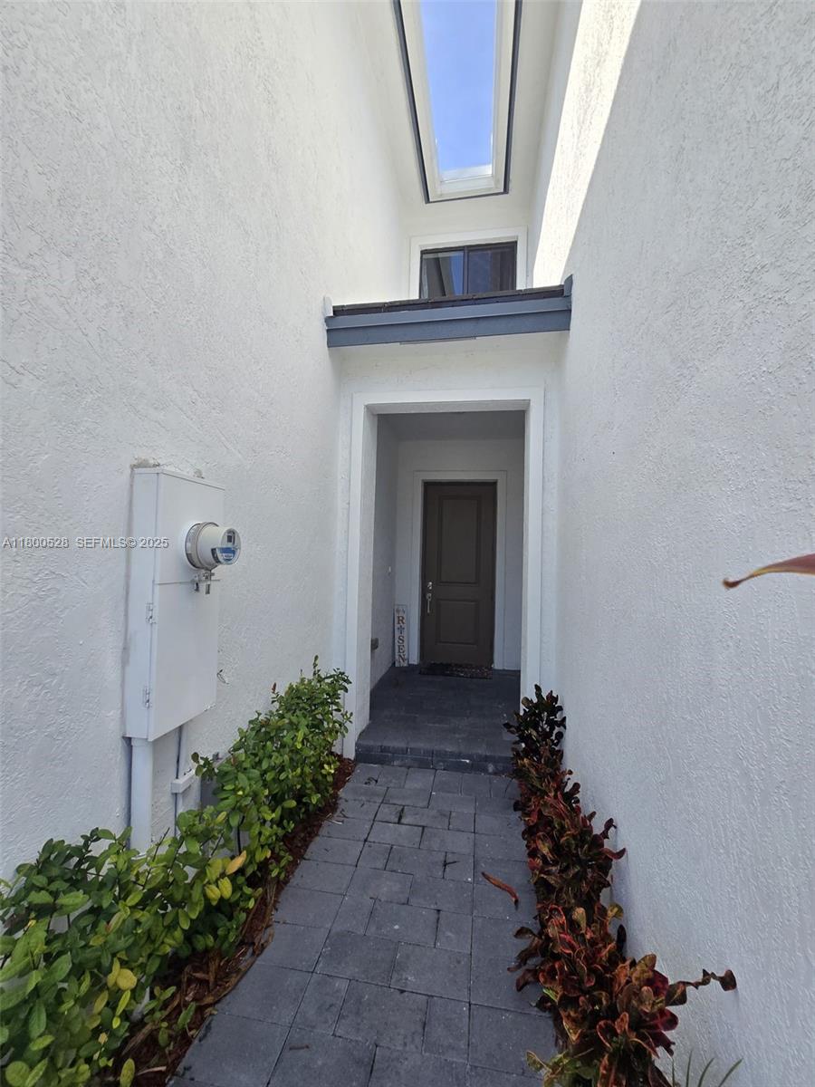 10847 Southwest 232nd Terrace Homestead, FL 33032 - Photo 5 of 29 a view of a hallway with flowers