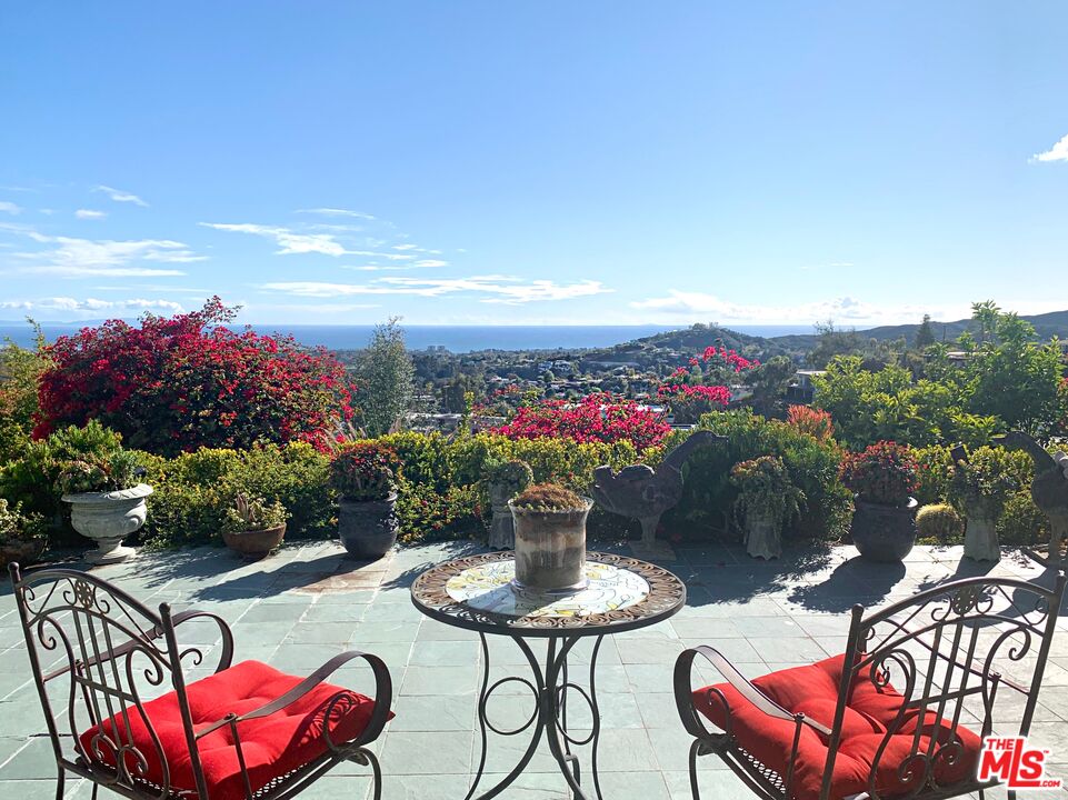 a view of a chairs and table in patio