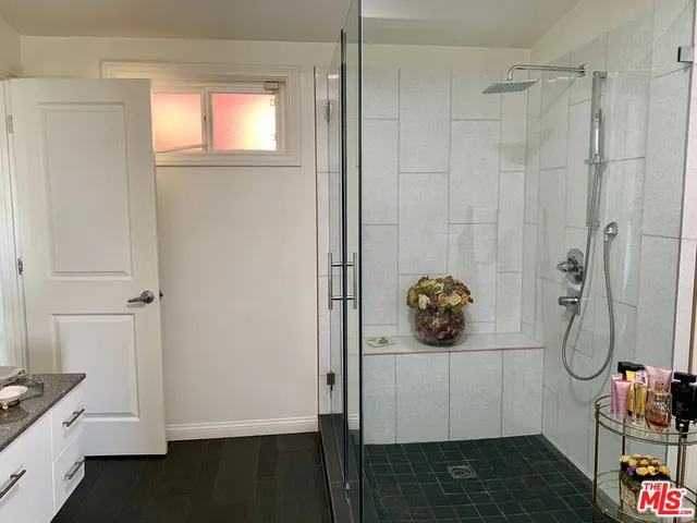 a bedroom with a bed and a shower