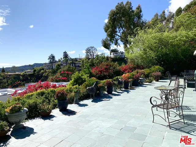a view of a chairs and tables in the back yard of the house