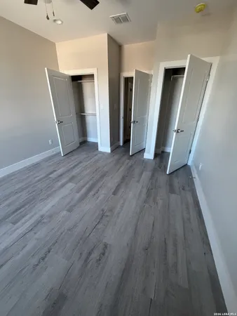 an empty room with wooden floor and closet