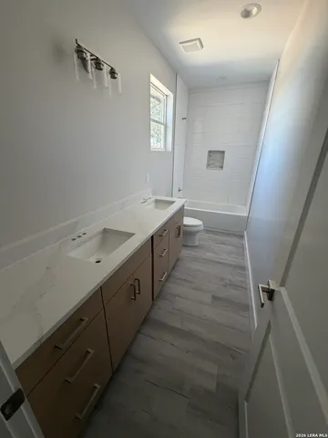 a spacious bathroom with a double vanity sink and a mirror