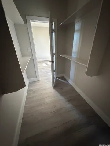 a room with a refrigerator and a stove top oven