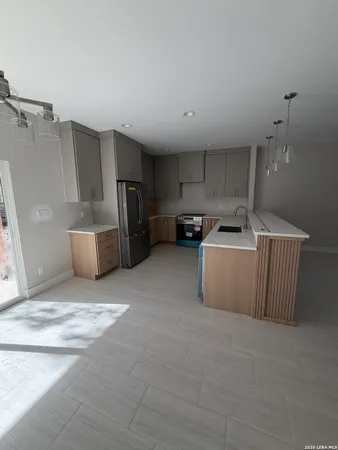 a kitchen with refrigerator and microwave