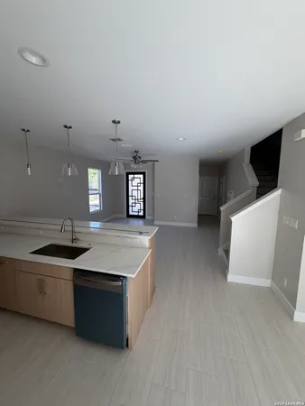 a kitchen with stainless steel appliances a sink stove and cabinets