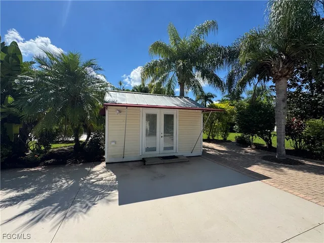a view of a house with a yard and parking space