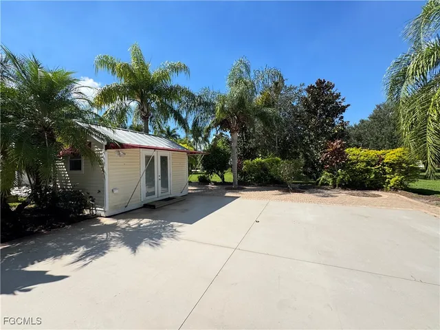 a view of a house with a yard and tree s