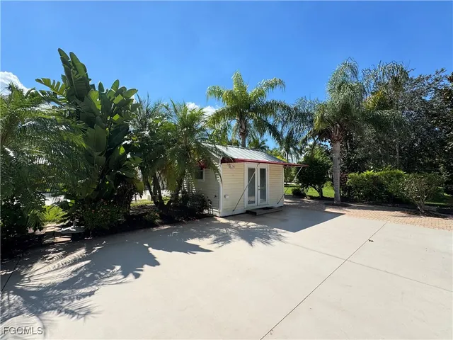 a view of a house with a tree in front of it