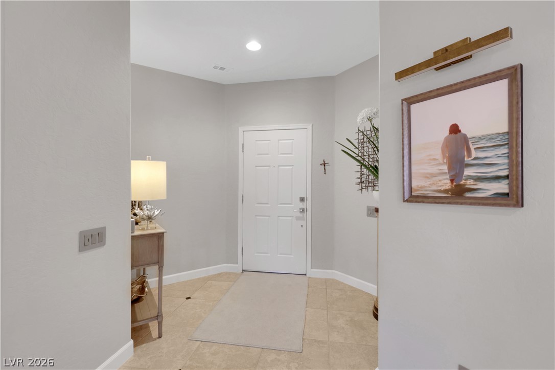 2635 Dirleton Place Henderson, NV 89044 - Photo 7 of 50 A welcoming entryway with neutral walls, recessed lighting, and durable tile flooring.