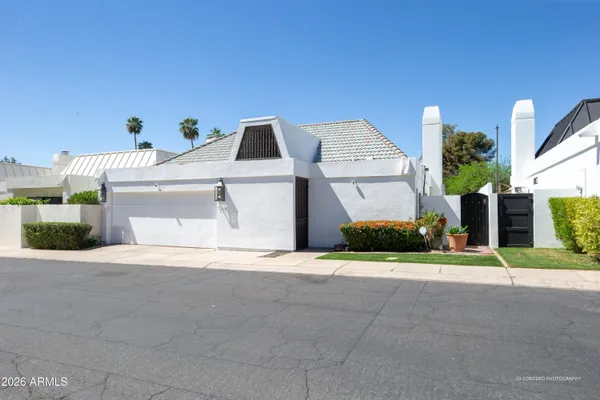 a view of a house with a yard and garage