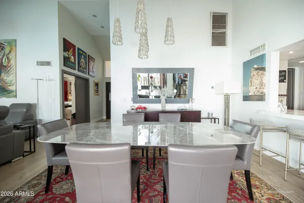 a view of a dining room with furniture and a chandelier