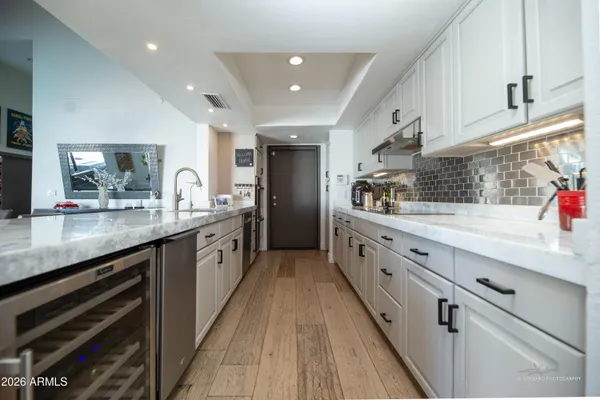 a large kitchen with stainless steel appliances lots of counter space and wooden floor