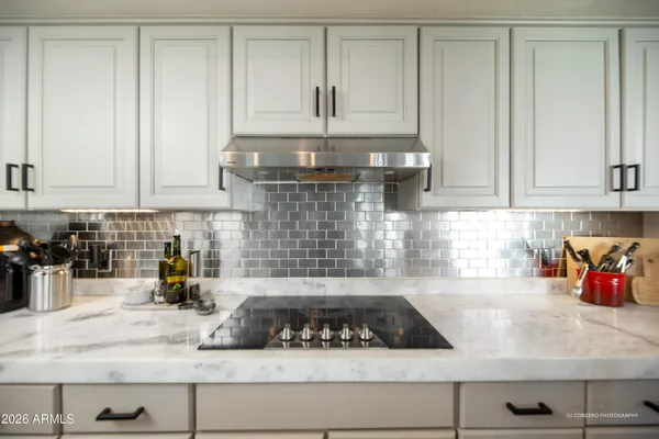a kitchen with white cabinets and appliances