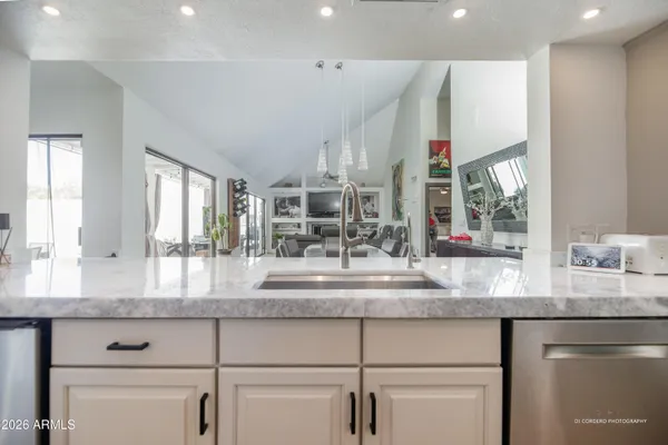 a kitchen with granite countertop a sink and cabinets