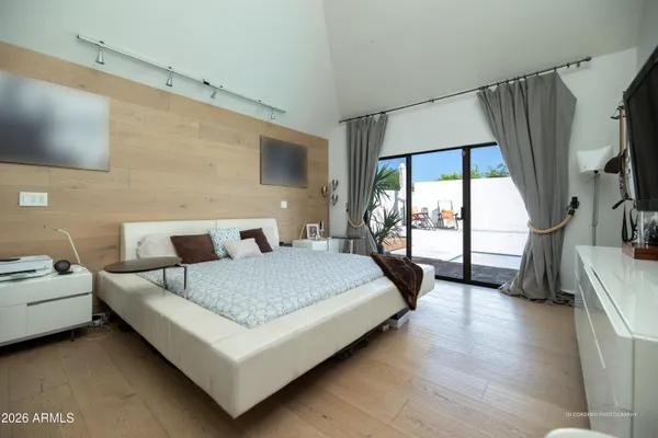 a bedroom with a large bed and a large window