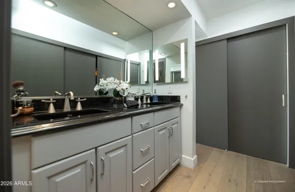 a bathroom with a double vanity sink and a mirror