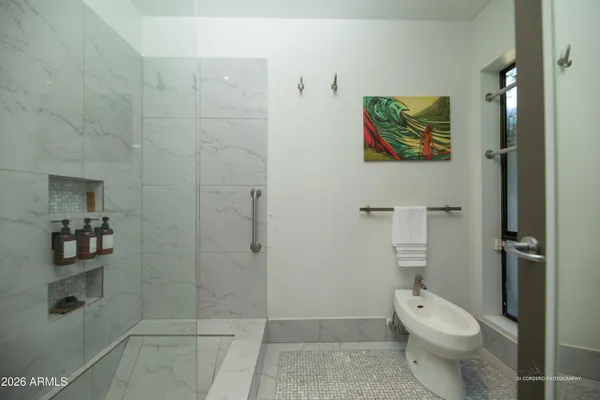 a white toilet sitting next to a bathroom sink and vanity