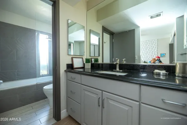 a bathroom with a double vanity sink and a mirror