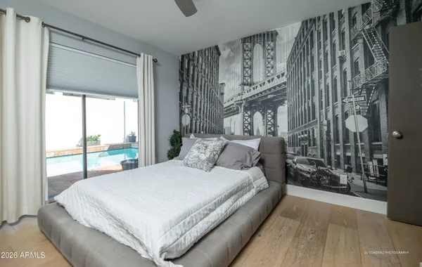 a large bed sitting in a bedroom next to a window